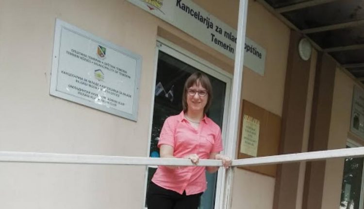 Disabilities advocate Mónika Zsúnyi, 26, stands front of the local youth office in her town of Temerin, Serbia. Photo courtesy Mónika Zsúnyi