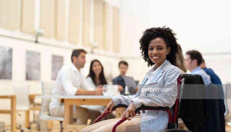Wheelchair Leadership Businesswoman Portrait at Business Meeting - stock photo